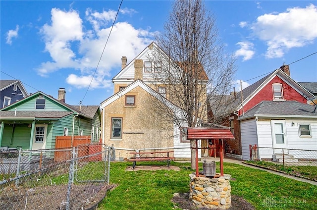 322 Hickory St, Dayton, OH 45410 - rear view of property with a lawn, fence, and stucco siding