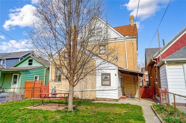 322 Hickory St, Dayton, OH 45410 - back of house with fence and a lawn