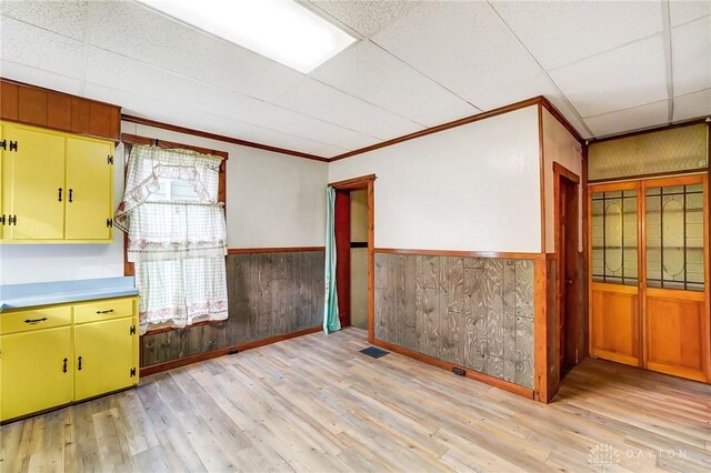 322 Hickory St, Dayton, OH 45410 - unfurnished room with wooden walls, wainscoting, light wood-type flooring, and a paneled ceiling
