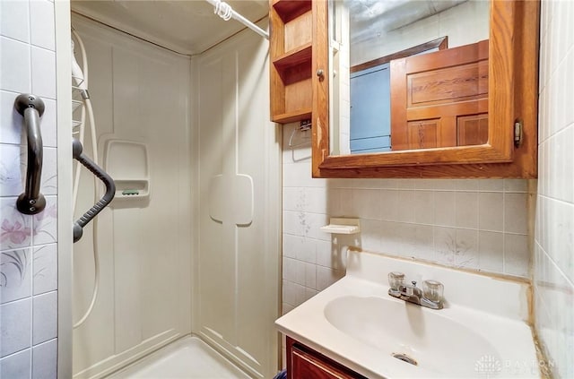322 Hickory St, Dayton, OH 45410 - full bathroom with decorative backsplash, vanity, tile walls, and a shower stall