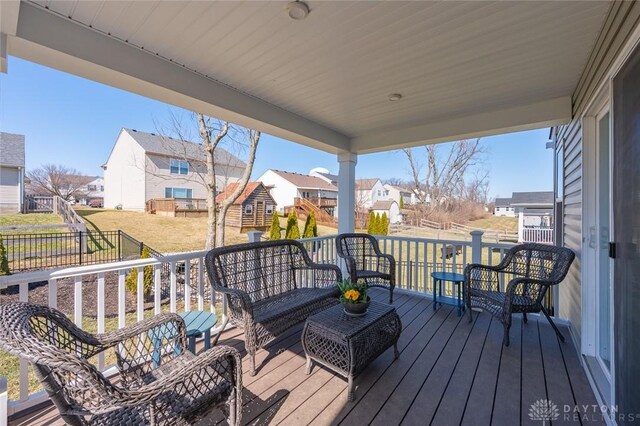 wooden deck featuring a residential view and fence