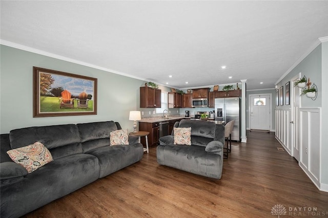 living room featuring crown molding, dark wood-type flooring, and recessed lighting