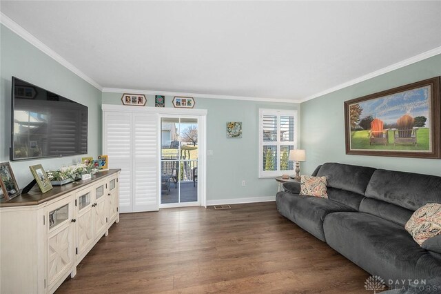 living room featuring ornamental molding and dark wood finished floors