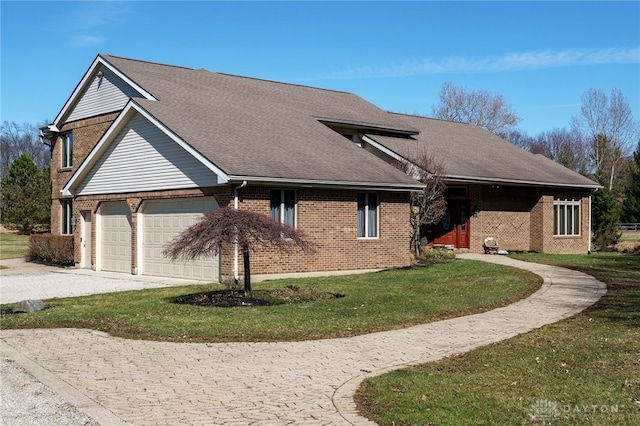 view of front of property with a front yard, an attached garage, brick siding, and driveway
