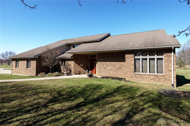 exterior space with a front lawn and brick siding
