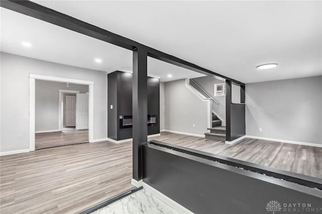 workout room featuring recessed lighting, baseboards, and wood finished floors