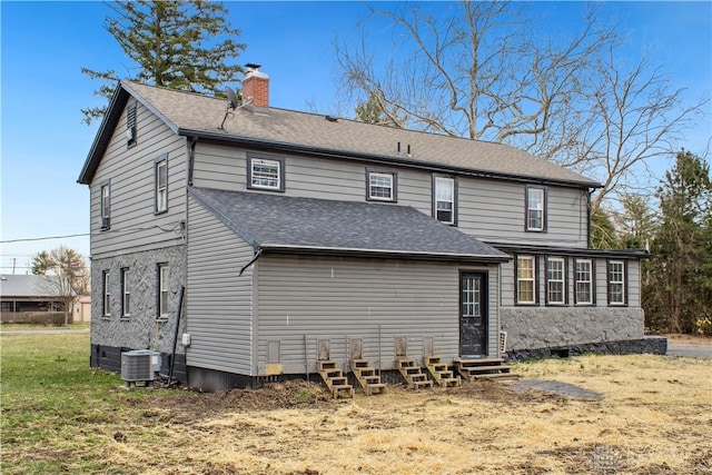 4385 N Hyland Ave, Dayton, OH 45424 - back of house with a shingled roof, central air condition unit, entry steps, a lawn, and a chimney