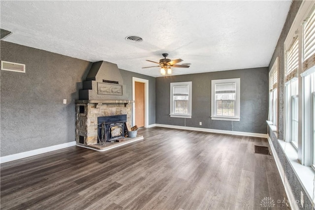 4385 N Hyland Ave, Dayton, OH 45424 - unfurnished living room featuring wood finished floors, visible vents, baseboards, a wood stove, and ceiling fan