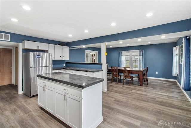 4385 N Hyland Ave, Dayton, OH 45424 - kitchen with light wood-style flooring, visible vents, white cabinets, and freestanding refrigerator