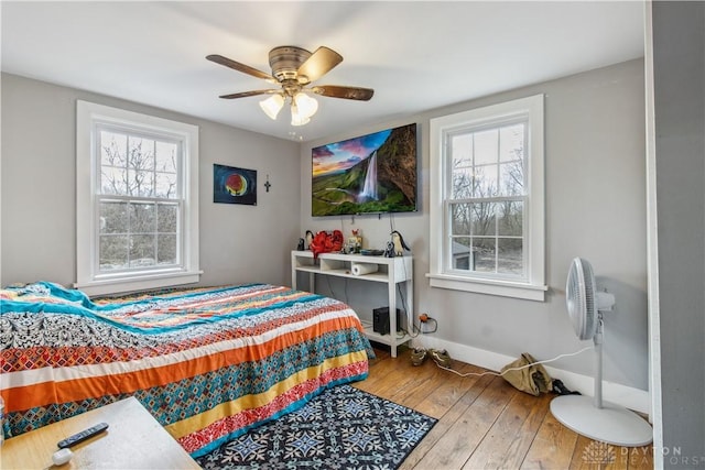4385 N Hyland Ave, Dayton, OH 45424 - bedroom with multiple windows, ceiling fan, baseboards, and hardwood / wood-style floors