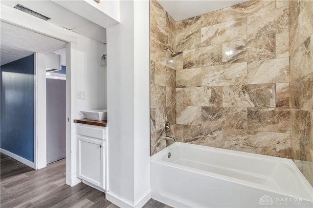 4385 N Hyland Ave, Dayton, OH 45424 - full bath with tub / shower combination, vanity, baseboards, and wood finished floors