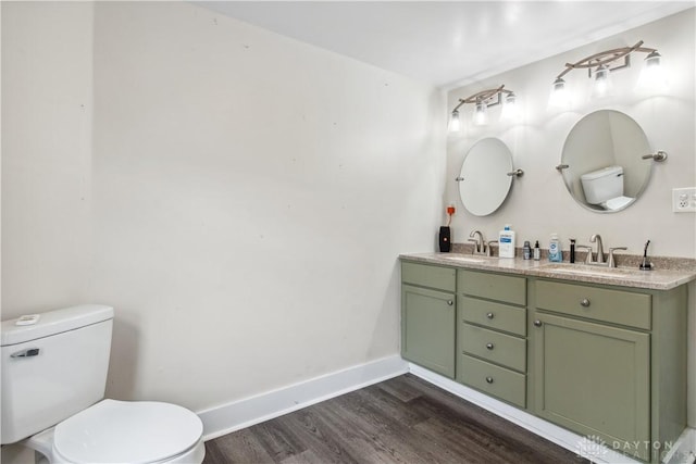 4385 N Hyland Ave, Dayton, OH 45424 - bathroom with a sink, baseboards, toilet, and wood finished floors