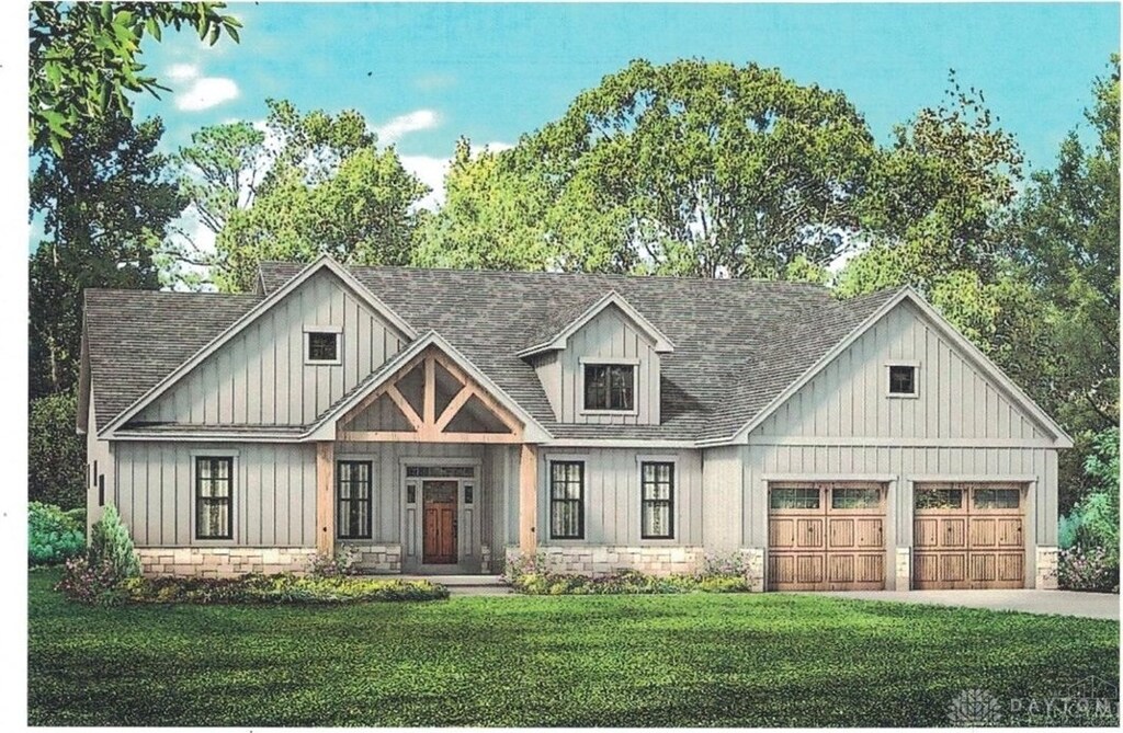view of front facade featuring a front lawn, concrete driveway, board and batten siding, and roof with shingles