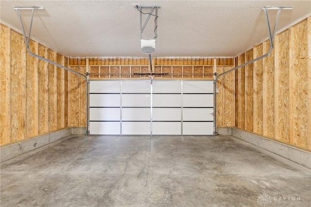 garage with wooden walls and a garage door opener
