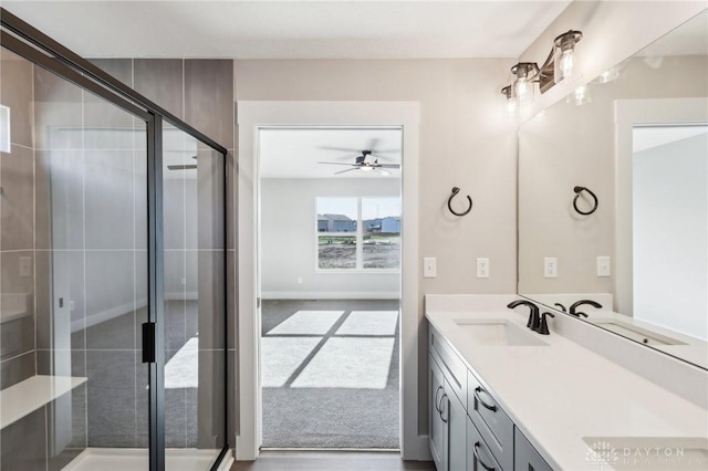 bathroom featuring vanity, a ceiling fan, and a stall shower