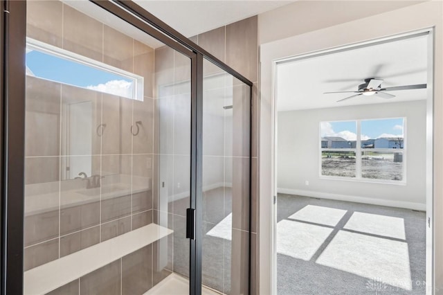bathroom with a shower stall, a ceiling fan, and a wealth of natural light