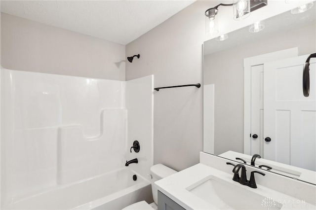 bathroom featuring shower / bathing tub combination, toilet, and vanity