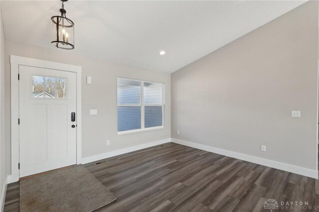 foyer with dark wood finished floors, lofted ceiling, recessed lighting, and baseboards
