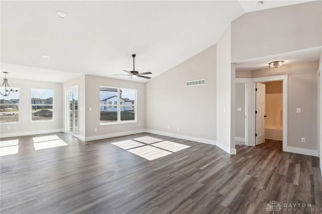 unfurnished living room with vaulted ceiling, wood finished floors, visible vents, and baseboards