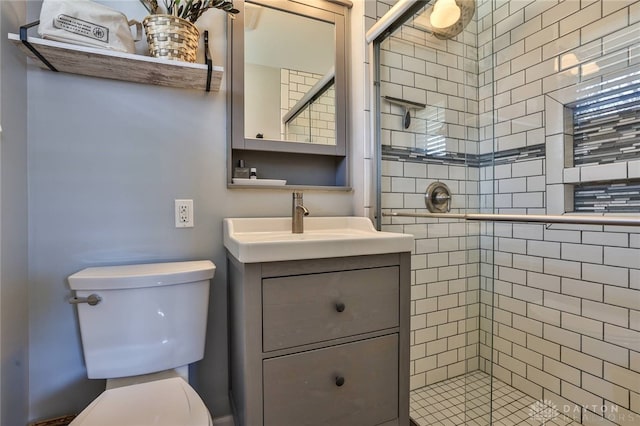 full bathroom featuring toilet, a stall shower, and vanity