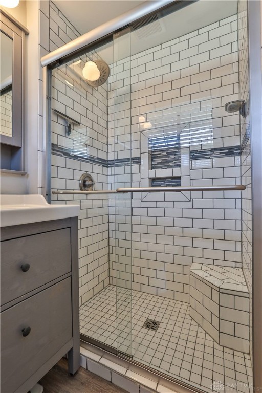 bathroom featuring vanity and a stall shower