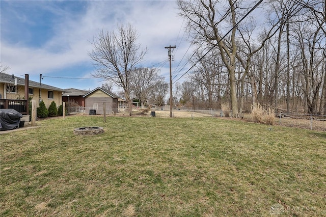 view of yard featuring a fire pit and fence