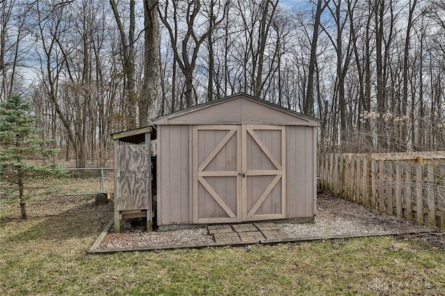 view of shed featuring fence