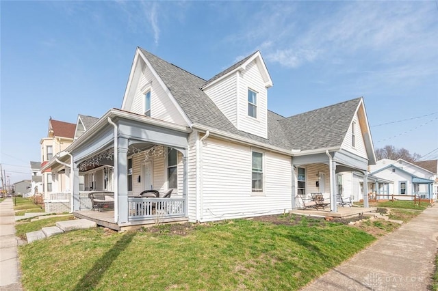 131 S Mulberry St, Troy, OH 45373 - view of side of home with covered porch, a lawn, and roof with shingles