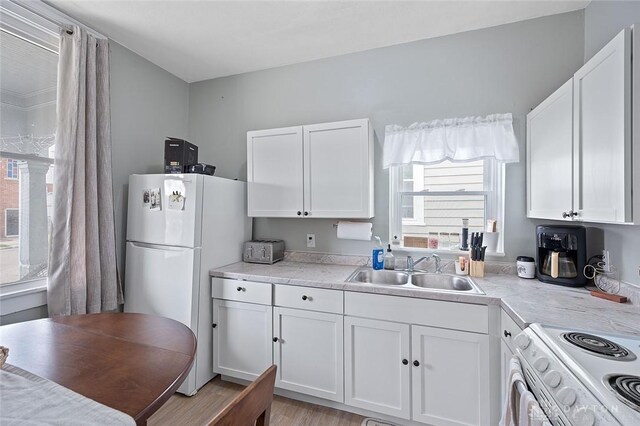 131 S Mulberry St, Troy, OH 45373 - kitchen featuring white appliances, white cabinets, and light countertops