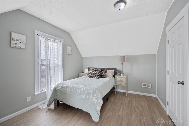 131 S Mulberry St, Troy, OH 45373 - bedroom featuring lofted ceiling and wood finished floors