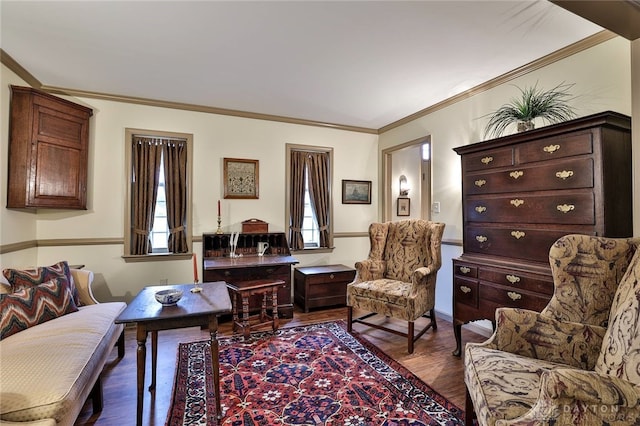 living area featuring ornamental molding and dark wood-style flooring