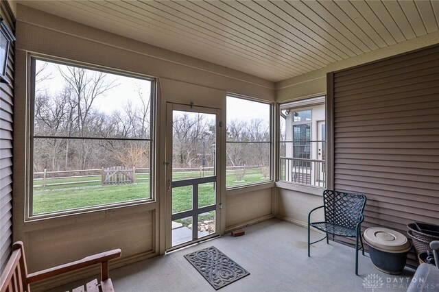 unfurnished sunroom with carpet floors
