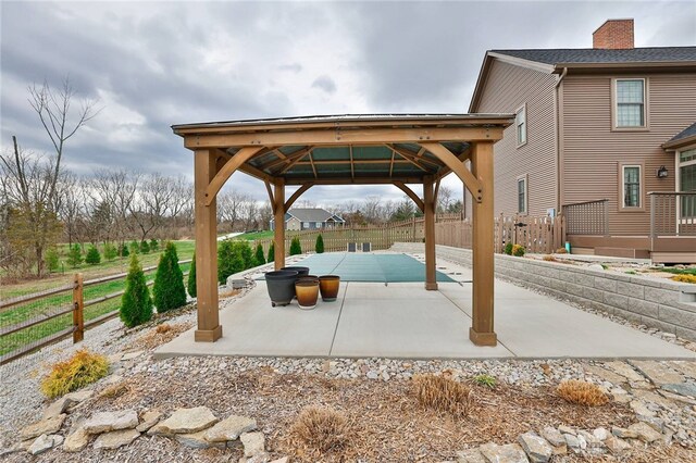 view of patio / terrace with fence and a gazebo