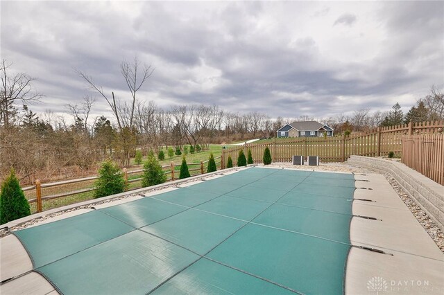 view of pool with a covered pool and fence