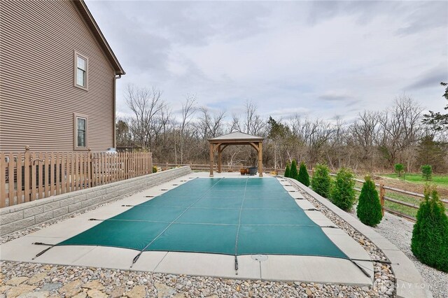 view of swimming pool with fence, a gazebo, and a fenced in pool