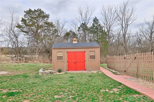 view of shed featuring fence