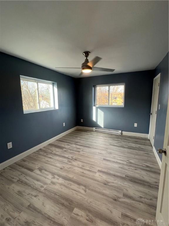 225 Victor Ave, Dayton, OH 45405 - spare room with a ceiling fan, wood finished floors, baseboards, and baseboard heating