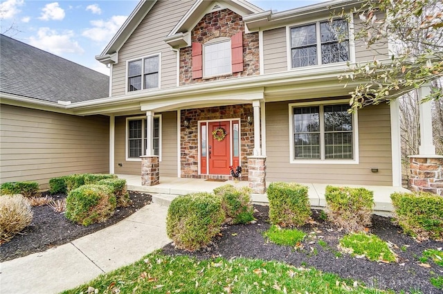 view of front of house featuring stone siding and covered porch