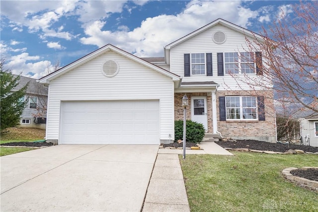 traditional-style home with a front lawn, concrete driveway, and a garage