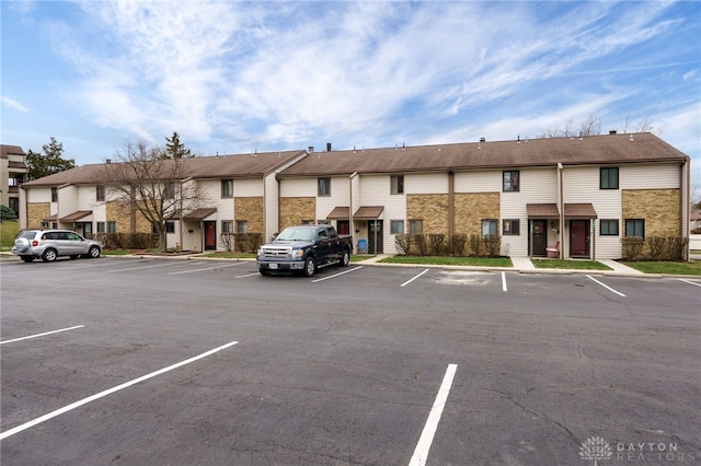 view of property with uncovered parking