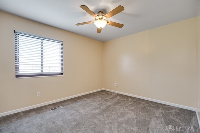 empty room featuring baseboards, visible vents, ceiling fan, and carpet flooring