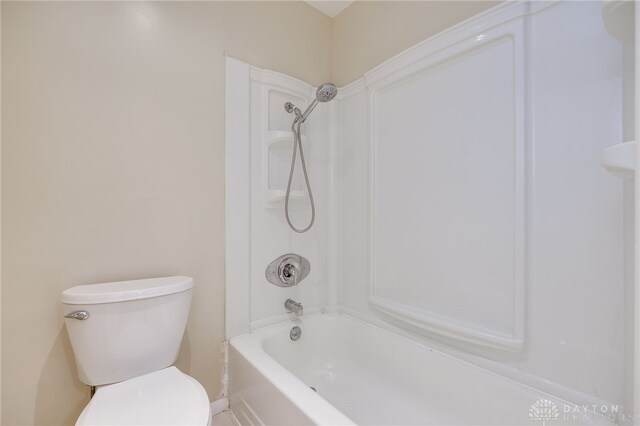 bathroom with toilet and tub / shower combination