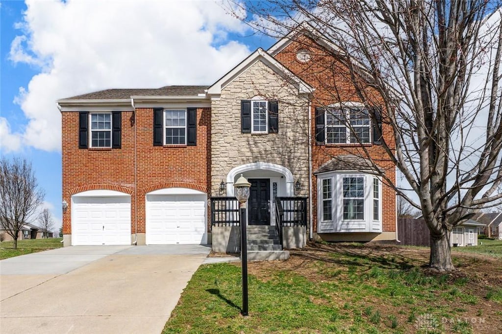 1315 Sierra Ridge Dr, Miamisburg, OH 45342 - view of front of home featuring brick siding, concrete driveway, a front lawn, and an attached garage