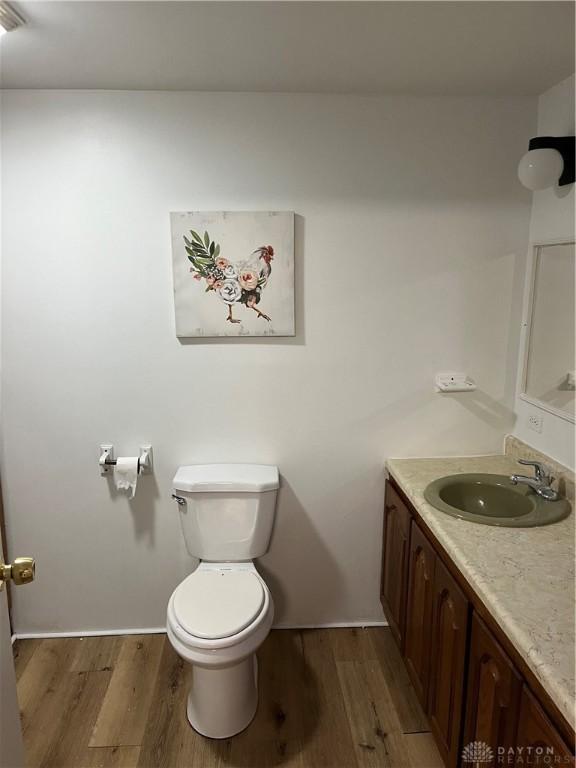 526 Corwin St, Dayton, OH 45410 - bathroom with vanity, toilet, and wood finished floors