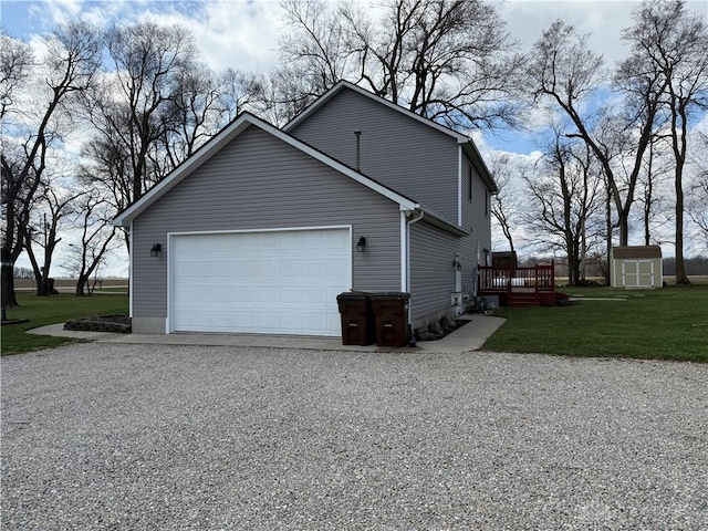 view of home's exterior featuring driveway, a shed, a yard, an outdoor structure, and a garage