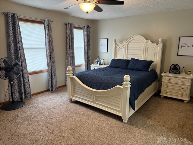 carpeted bedroom with baseboards, a textured ceiling, and a ceiling fan