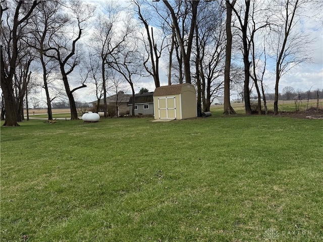 view of yard with a storage unit and an outbuilding