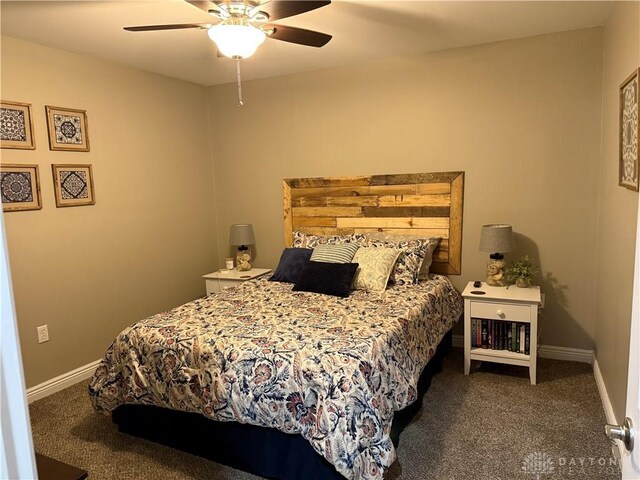 carpeted bedroom with a ceiling fan and baseboards