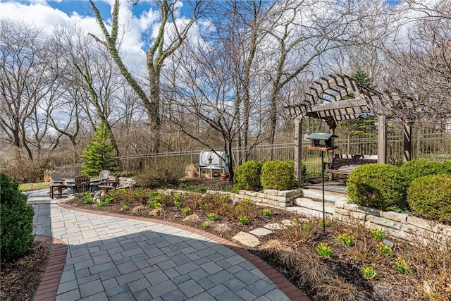 exterior space featuring a pergola and fence