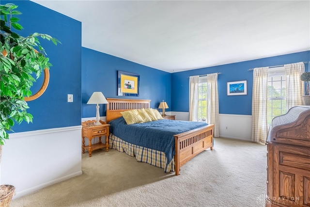 carpeted bedroom featuring baseboards